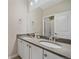 Bright bathroom showcasing a double sink vanity with gray countertop, large mirror and modern fixtures at 14589 Hagus Pl, Parker, CO 80134