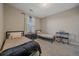 Neutral bedroom with twin beds, dark wood furnishings, soft carpet, and natural light at 14589 Hagus Pl, Parker, CO 80134