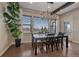 Bright dining room featuring hardwood floors, a modern chandelier, and large windows offering scenic views at 14589 Hagus Pl, Parker, CO 80134