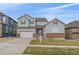 Charming two-story home with attached two car garage and manicured front yard at 14589 Hagus Pl, Parker, CO 80134