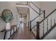 Grand foyer with an open staircase, hardwood floors and a modern table at 14589 Hagus Pl, Parker, CO 80134