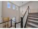 Open foyer with lots of natural light from many large windows, stairs, and a modern pendant light at 14589 Hagus Pl, Parker, CO 80134
