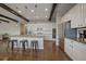 Modern kitchen with stainless appliances, large island with seating, and dark hardwood floors at 14589 Hagus Pl, Parker, CO 80134