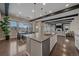 Open concept kitchen with stainless steel appliances, dark beams and hardwood floors at 14589 Hagus Pl, Parker, CO 80134