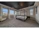 Spacious main bedroom with a four-poster bed, plush carpet, and abundant natural light at 14589 Hagus Pl, Parker, CO 80134