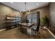 Stylish office featuring hardwood floors, unique light fixture, shelving, and a comfortable workspace at 14589 Hagus Pl, Parker, CO 80134