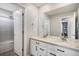 Bright bathroom with double vanity, granite countertops and a tub shower at 16195 Red Bud Loop, Parker, CO 80134