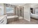 Bathroom featuring tile flooring, soaking tub and glass enclosed shower at 16195 Red Bud Loop, Parker, CO 80134