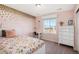 Cozy bedroom with a floral bedspread, accent wall and large window at 16195 Red Bud Loop, Parker, CO 80134