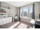 Bright bedroom with a large window, neutral carpet, and a built-in bookshelf at 16195 Red Bud Loop, Parker, CO 80134