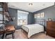 Comfortable bedroom features a cozy bed, wooden desk and modern shelving at 16195 Red Bud Loop, Parker, CO 80134