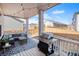 Inviting covered patio with grill and outdoor seating area at 16195 Red Bud Loop, Parker, CO 80134