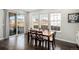 Sunlit dining area featuring hardwood floors, modern windows, and a sliding glass door to the outdoor patio at 16195 Red Bud Loop, Parker, CO 80134