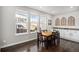 Bright dining area with three windows, a dining table, and additional cabinet storage with granite countertop at 16195 Red Bud Loop, Parker, CO 80134