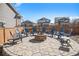 Stone patio with a fire pit and seating surrounded by a fenced yard at 16195 Red Bud Loop, Parker, CO 80134