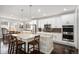 Spacious kitchen with a large island, stainless steel appliances, and dark wood floors at 16195 Red Bud Loop, Parker, CO 80134