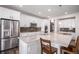 Bright kitchen featuring a large island with granite countertops, stainless appliances, and white cabinetry at 16195 Red Bud Loop, Parker, CO 80134