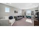 Bright living room featuring neutral walls, carpeting, and comfortable seating at 16195 Red Bud Loop, Parker, CO 80134