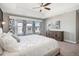 Sun-filled main bedroom featuring a tray ceiling, large bed and a stylish dresser at 16195 Red Bud Loop, Parker, CO 80134