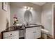 Well-lit bathroom features a granite countertop, vanity and decorative mirror at 7755 E Quincy Ave # 104A1, Denver, CO 80237