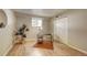 Serene bedroom with wood floors, a cozy workspace, and ample closet space at 7755 E Quincy Ave # 104A1, Denver, CO 80237