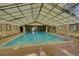 Bright indoor pool with vaulted skylight and refreshing blue water at 7755 E Quincy Ave # 104A1, Denver, CO 80237