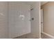 Newly remodeled tiled shower with modern fixtures and a sleek design at 7755 E Quincy Ave # 104A1, Denver, CO 80237