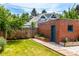 Charming backyard featuring a wood walkway to the garage and plenty of green space at 1776 S Logan St, Denver, CO 80210