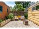 Backyard patio with stylish furniture, pea gravel and lush greenery at 1776 S Logan St, Denver, CO 80210