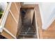 Stairs leading to the unfinished basement with brick and concrete foundation at 1776 S Logan St, Denver, CO 80210