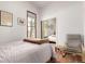 Cozy bedroom with warm hardwood floors, closet with mirror doors, and a chair at 1776 S Logan St, Denver, CO 80210