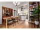 Dining area with a wooden table, a cabinet, and an open view into the modern kitchen at 1776 S Logan St, Denver, CO 80210