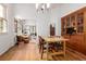 Bright dining room with hardwood floors and a large hutch, open to the living room at 1776 S Logan St, Denver, CO 80210