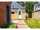 Garage exterior with wood walkway and a well-maintained yard at 1776 S Logan St, Denver, CO 80210
