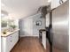 Open kitchen with modern stainless steel appliances and bright natural light at 1776 S Logan St, Denver, CO 80210
