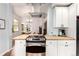 Kitchen showcasing the center island with breakfast bar and stainless gas range at 1776 S Logan St, Denver, CO 80210
