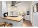 Bright kitchen featuring a center island, stainless appliances, and wooden flooring at 1776 S Logan St, Denver, CO 80210