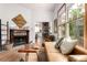 Inviting living room with a cozy fireplace, hardwood floors, and a comfortable leather couch at 1776 S Logan St, Denver, CO 80210
