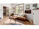 Stylish living room with a unique coffee table, hardwood floors, and plenty of natural light at 1776 S Logan St, Denver, CO 80210
