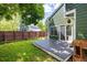 A lovely backyard featuring mature trees, a patio and raised garden beds at 4129 Amber St, Boulder, CO 80304