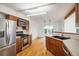 Modern kitchen with stainless steel appliances, warm wood cabinets, and hardwood floors at 4129 Amber St, Boulder, CO 80304
