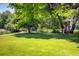 A grassy park has a volleyball net, walking path, and shady trees at 4129 Amber St, Boulder, CO 80304