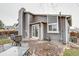 Backyard showcasing the home's exterior, a patio with outdoor seating, and mature landscaping at 6365 Xavier Ct, Arvada, CO 80003