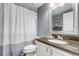 Bathroom featuring a shower with curtain, granite countertop, modern fixtures, and ample space at 6365 Xavier Ct, Arvada, CO 80003