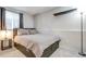 Bedroom featuring a modern bed with storage drawers, stylish decor, and a window for natural light at 6365 Xavier Ct, Arvada, CO 80003