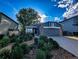 Inviting home featuring a charming front yard with mature landscaping and a two-car garage at 6365 Xavier Ct, Arvada, CO 80003
