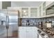 Bright kitchen with stainless steel appliances and white cabinets offers a modern design at 6365 Xavier Ct, Arvada, CO 80003