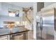 Open concept kitchen adjacent to dining area with stainless steel appliances and granite countertops at 6365 Xavier Ct, Arvada, CO 80003