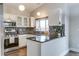 Stylish kitchen boasts granite countertops, modern appliances, and ample cabinet space at 6365 Xavier Ct, Arvada, CO 80003