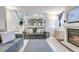 Spacious living area with stairs, comfortable seating, and a fireplace view to the dining area at 6365 Xavier Ct, Arvada, CO 80003